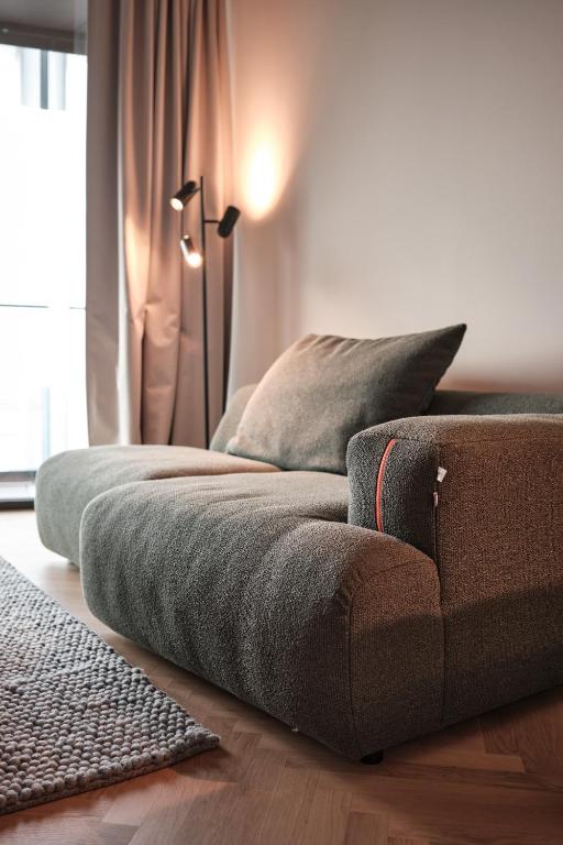 a couch sitting on the floor in a living room at The Zipper Hotel und Apartments in Düsseldorf