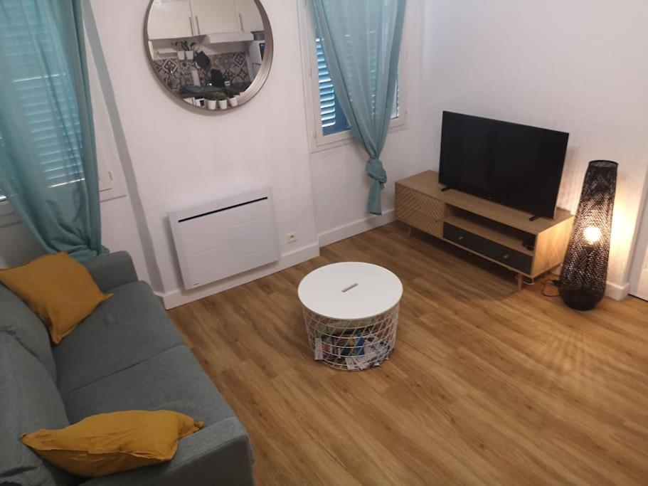 un salon avec un canapé et une télévision à écran plat dans l'établissement Appartement Mourillon à 80m des plages, à Toulon