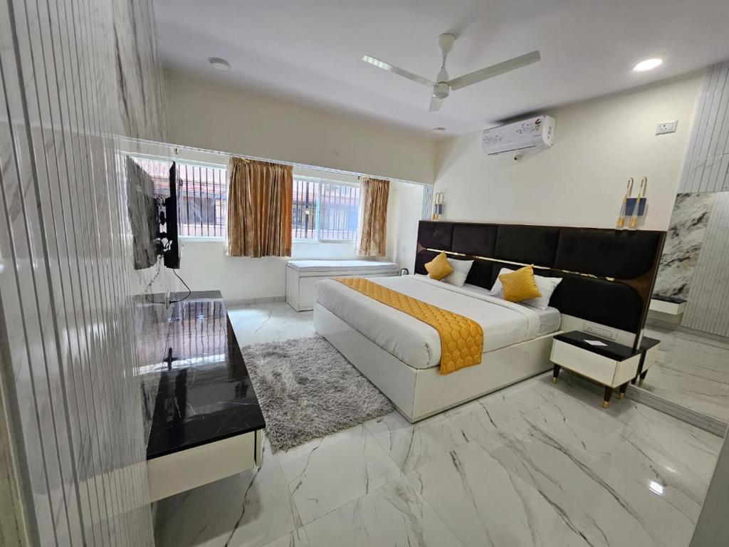 a large bedroom with a bed and a window at SS LUMINA GUEST HOUSE in Bangalore