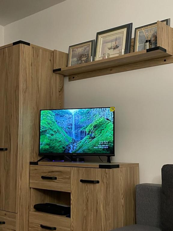 a flat screen tv sitting on top of a wooden cabinet at Gdynia Riviera Hills in Gdynia