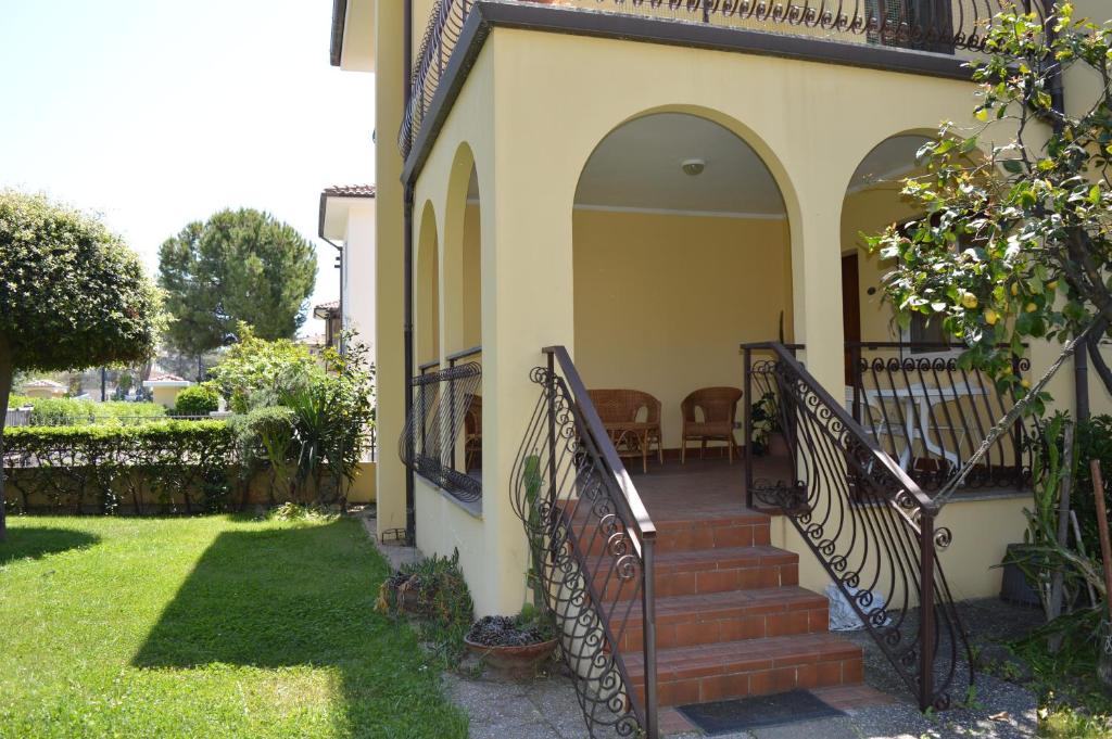 a house with a staircase in a yard at Homiday - Villino Caroli in Pineto