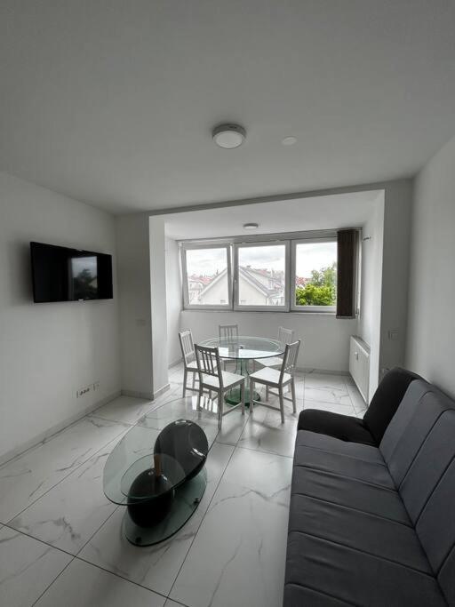 a living room with a couch and a table at Renewed 2 Bedroom Apartment with Parking in Ljubljana