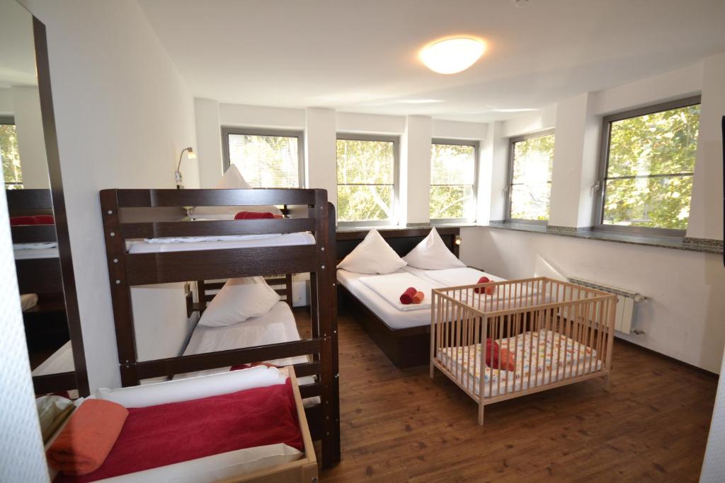 a small room with a bunk bed and a crib at Hostel Köln in Cologne