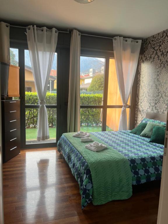 a bedroom with a bed and a large window at B&B Resilienza in Lecco