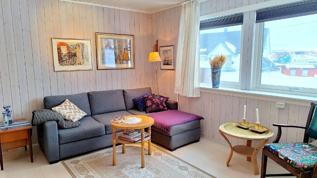 a living room with a couch and a table at Berlevåg Apartment in Berlevåg