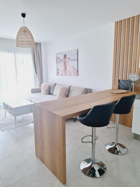 a large wooden table in a living room with a couch at Caesar Blue Resort Studio with Sea View in Trikomo