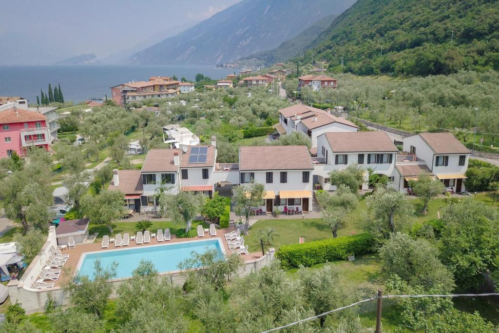 a village with a swimming pool and houses at Hotel Alesi in Malcesine