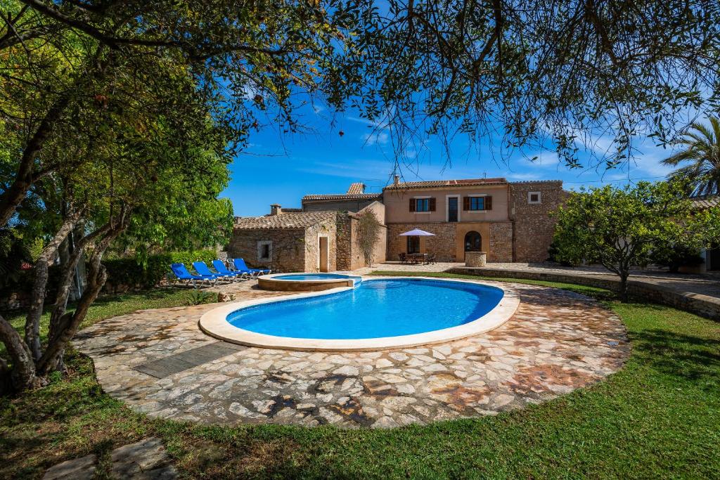 una piscina frente a una casa en Villa Es Pujol den Miquel, en Felanitx