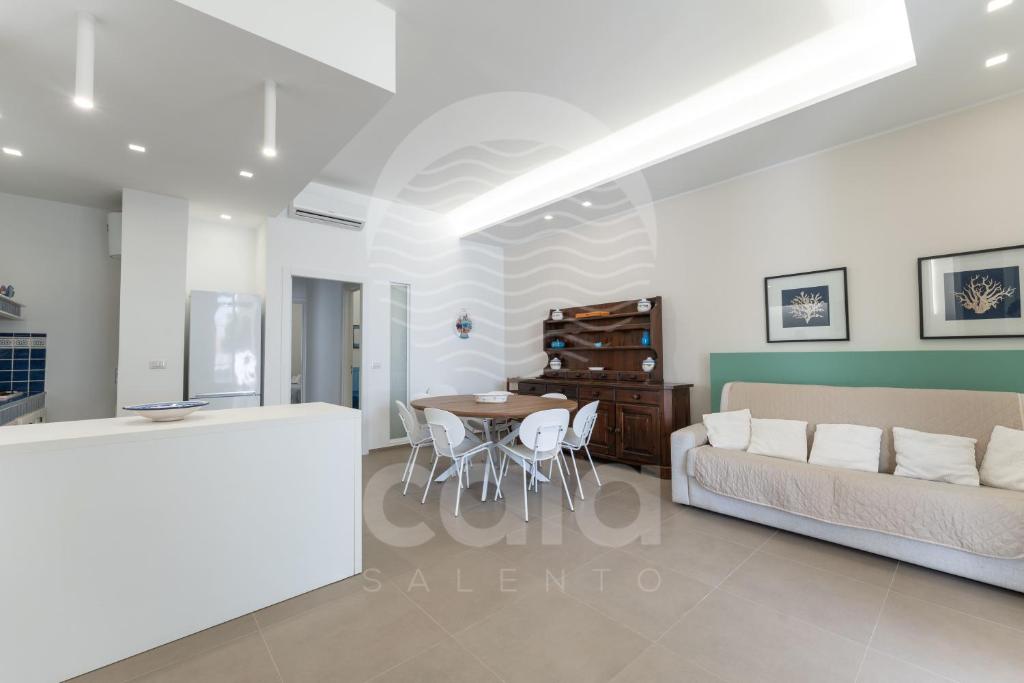 un soggiorno con un divano e un tavolo di Villa Giulia By Cala Salento a Torre Lapillo