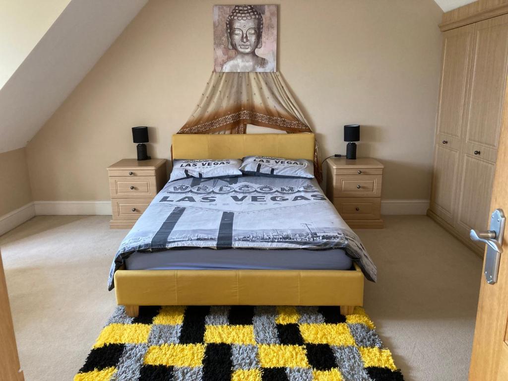 a bedroom with a king sized bed with a yellow headboard at Private room Bishop Norton in Market Rasen