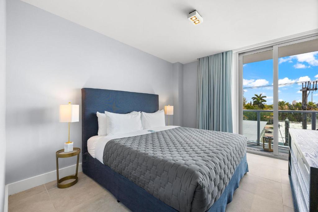 a bedroom with a bed and a large window at ABAE Hotel by Eskape Collection in Miami Beach