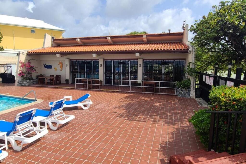 a patio with lounge chairs and a swimming pool at Another Beautiful Day In Paradise in Christiansted