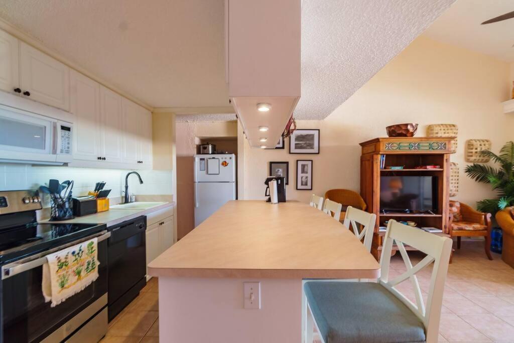 a kitchen with a counter top and a dining room at Another Beautiful Day In Paradise in Christiansted