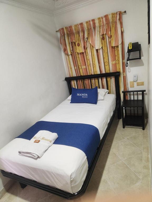 Voodi või voodid majutusasutuse Hotel Manoa toas