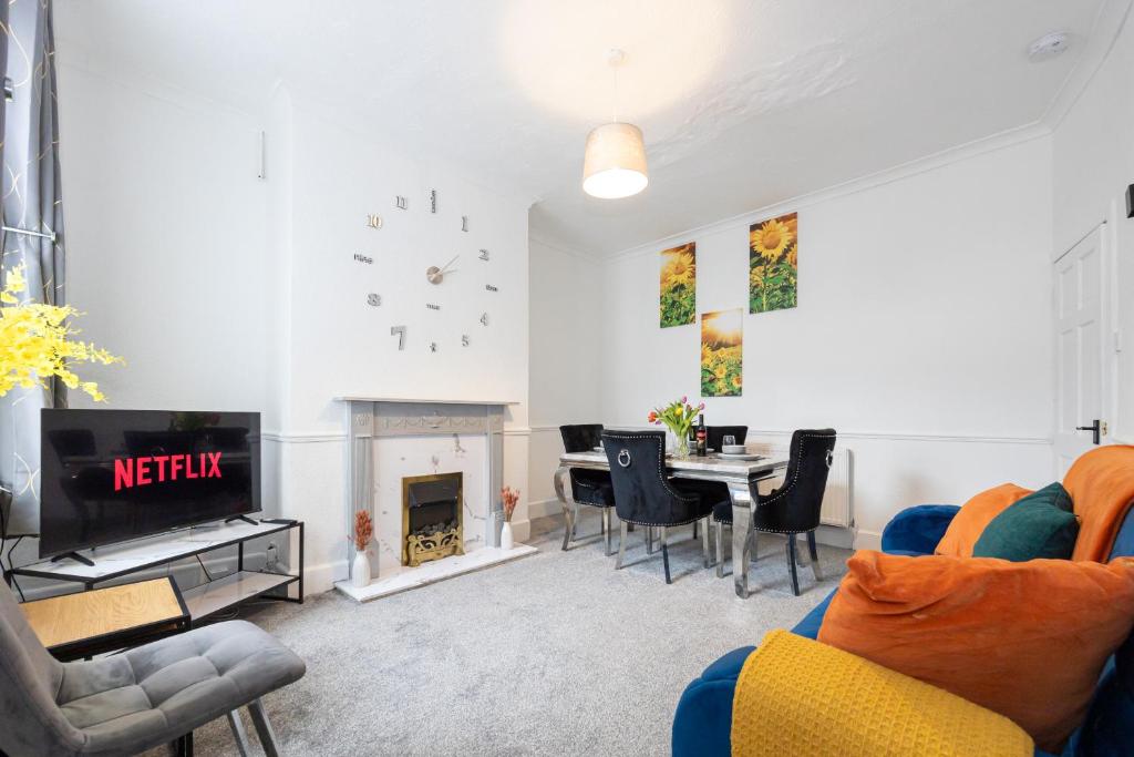 a living room with a table and a dining room at Cosy Three Bedroom Terrace Rishton in Rishton