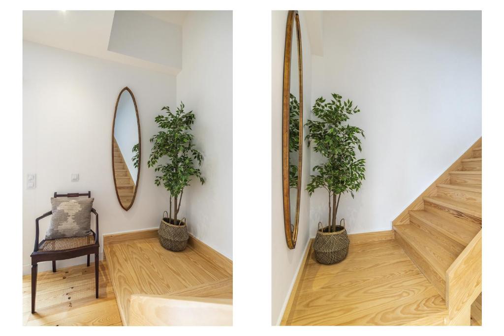 a room with a staircase and a mirror and two plants at Belém Design Apartments by Homing in Lisbon