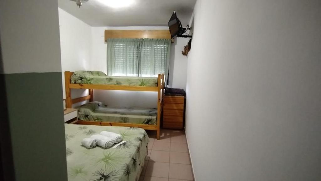 a small room with two bunk beds in it at Hostería Cerros Dorados de Cosquín in Cosquín