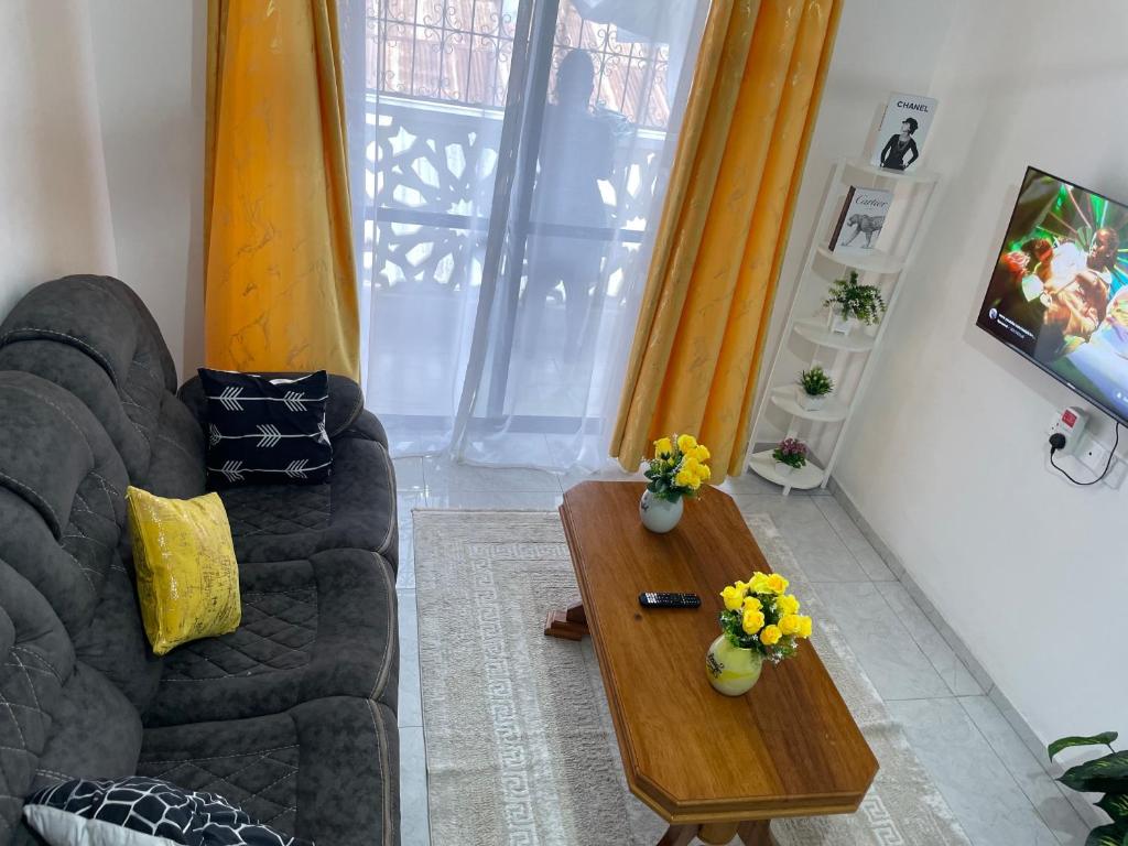a living room with a couch and a coffee table at Ngoki’s comfort apartment in Mombasa
