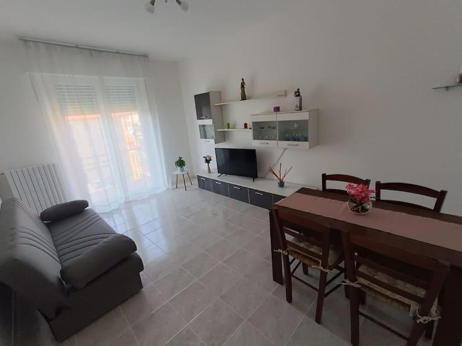 a living room with a couch and a table at Flori's Home in Bergamo