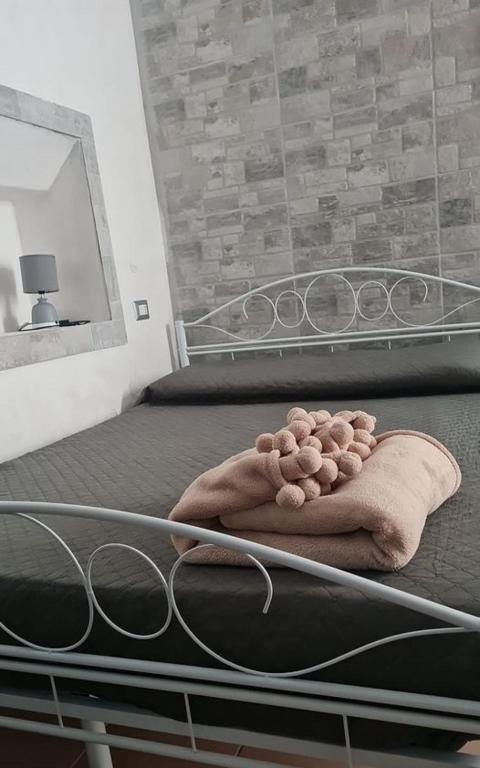 a blanket sitting on a bed in a bedroom at Casa Lucia Ortigia in Syracuse