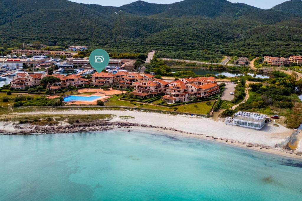 an aerial view of a resort on a beach at Marinella-Porto Rotondo, Accesso Diretto sulla SPIAGGIA in Porto Rotondo