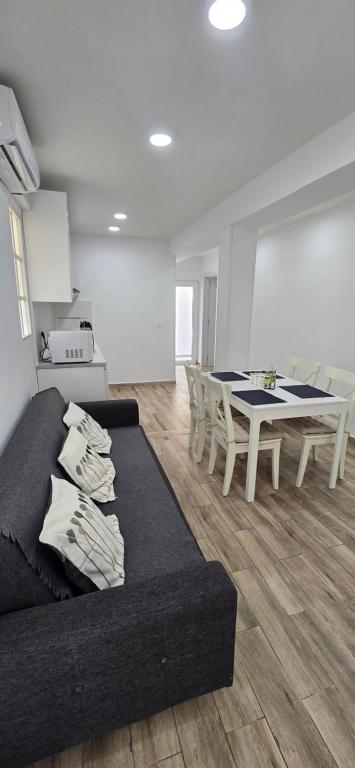 a living room with a couch and a table at 2 bedrooms, Las Plumas in Torremolinos