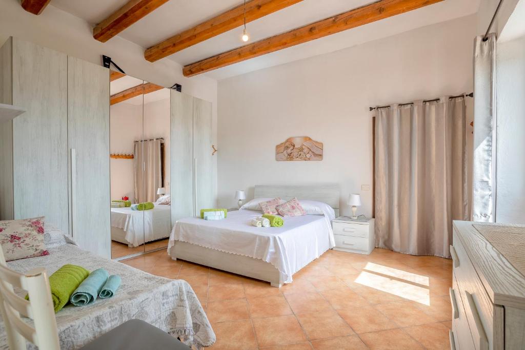 a bedroom with two beds in a room at Tenuta Ponte Vecchio in Bortigiadas