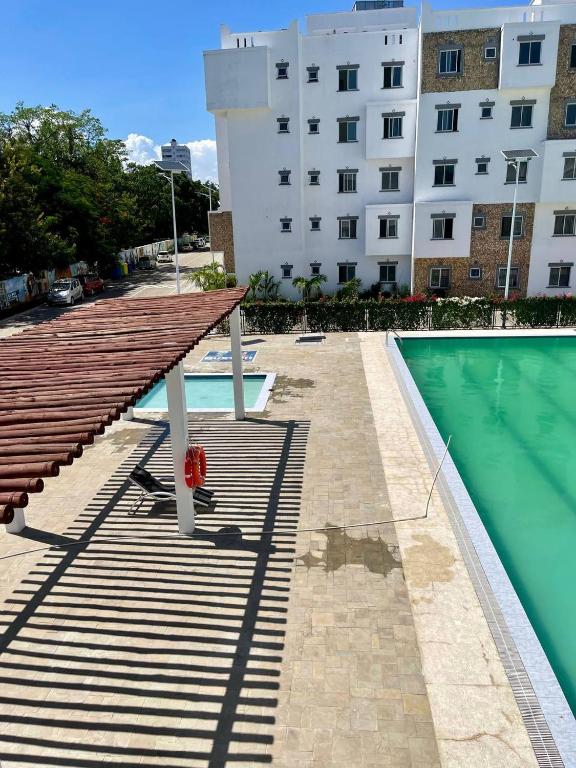 a swimming pool with a table next to a building at Pazuri Homes 2BD Apartment in Mombasa