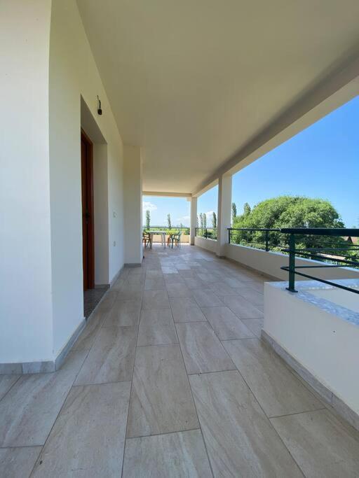 an empty balcony of a house with a view of the ocean at Ron Guesthouse 1 in Lezhë
