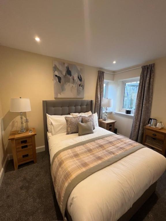 a bedroom with a large bed and a window at Waverley Inn House in Inverness