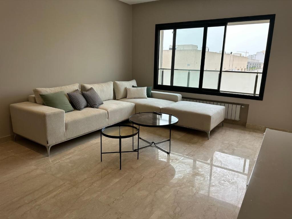a living room with a couch and a table at Luxury apartment s2 in Sidi Daoud
