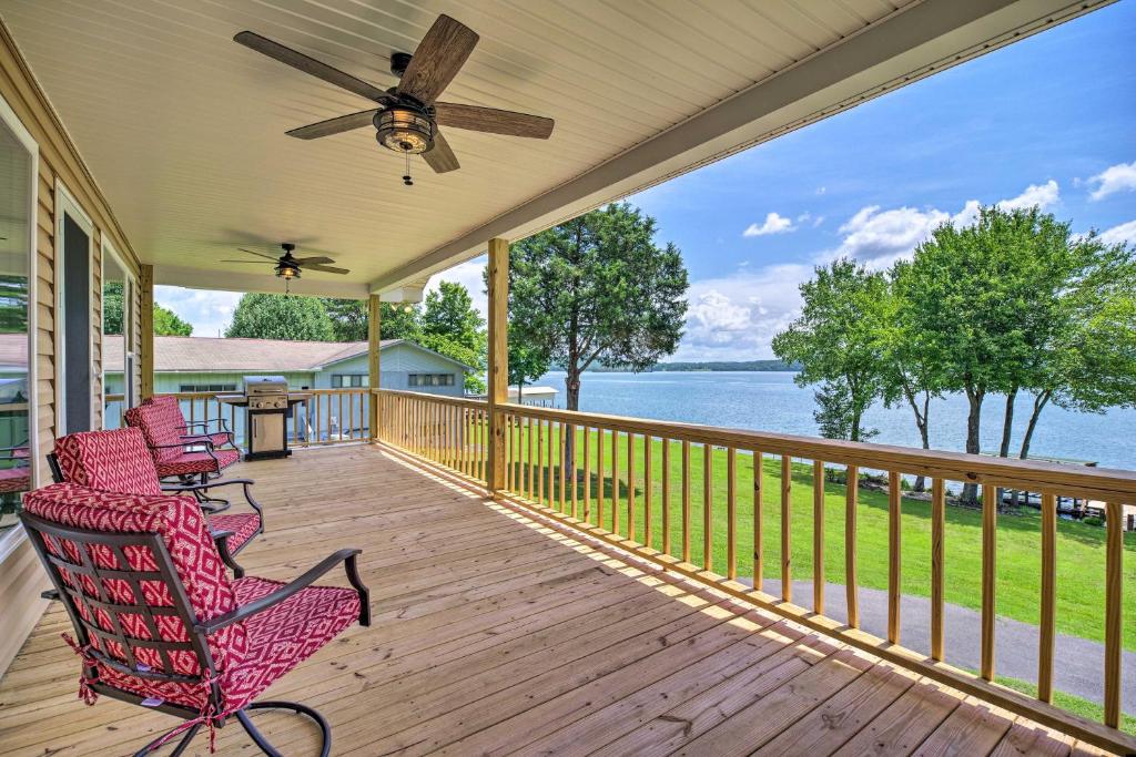 a porch with two chairs and a ceiling fan at Watts Bar Lake Escape Private Boat Dock and Ramp! in Spring City