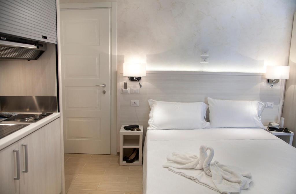 a bedroom with a bed with two swans on it at Hotel Residence Maria Grazia in Rimini