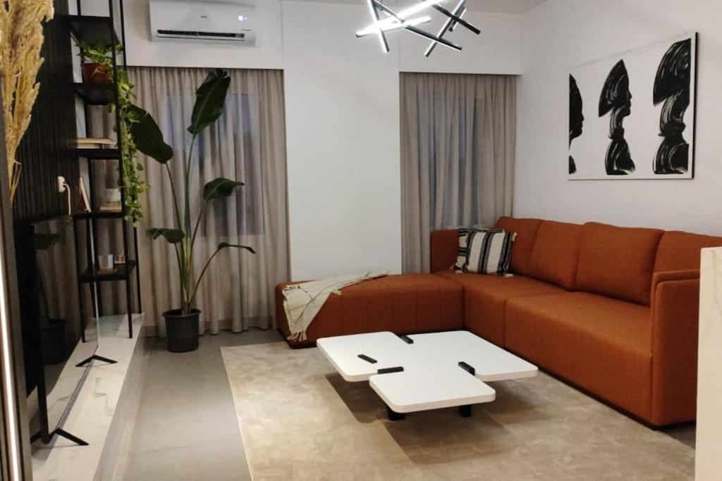 a living room with a couch and a coffee table at Rita's 2-BR Apt in Mar Mikhael in Beirut