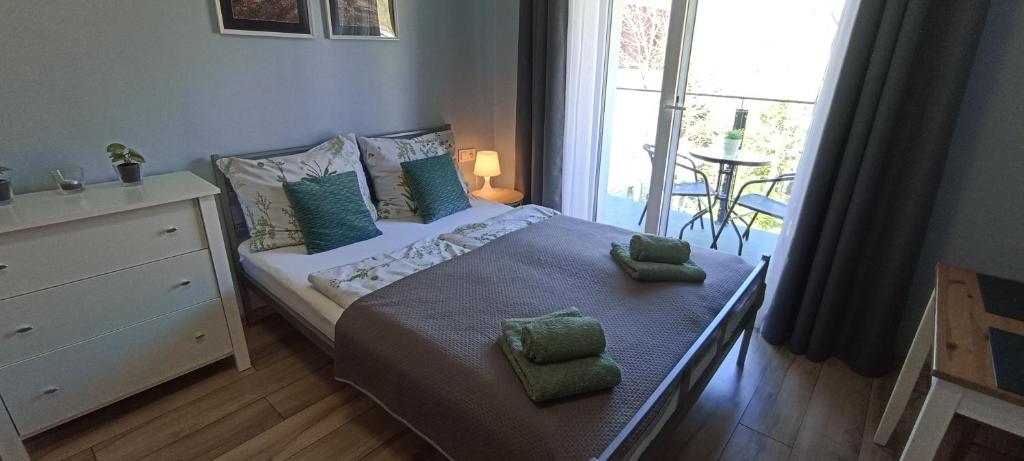 Posteľ alebo postele v izbe v ubytovaní Apartamenty Gościnne Idylla