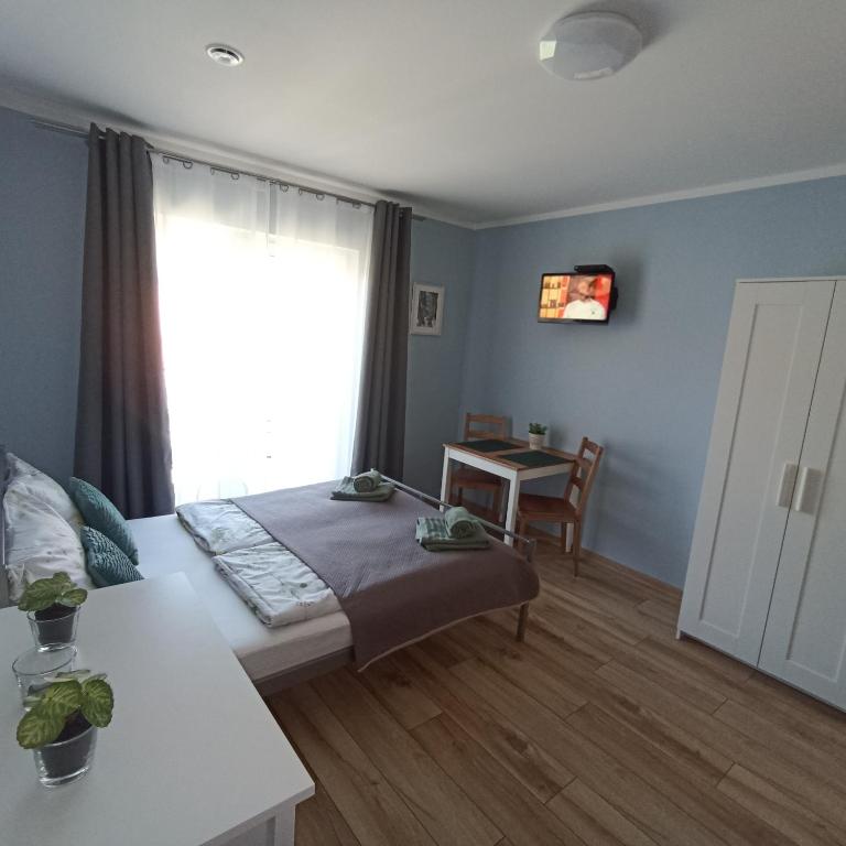 Posteľ alebo postele v izbe v ubytovaní Apartamenty Gościnne Idylla