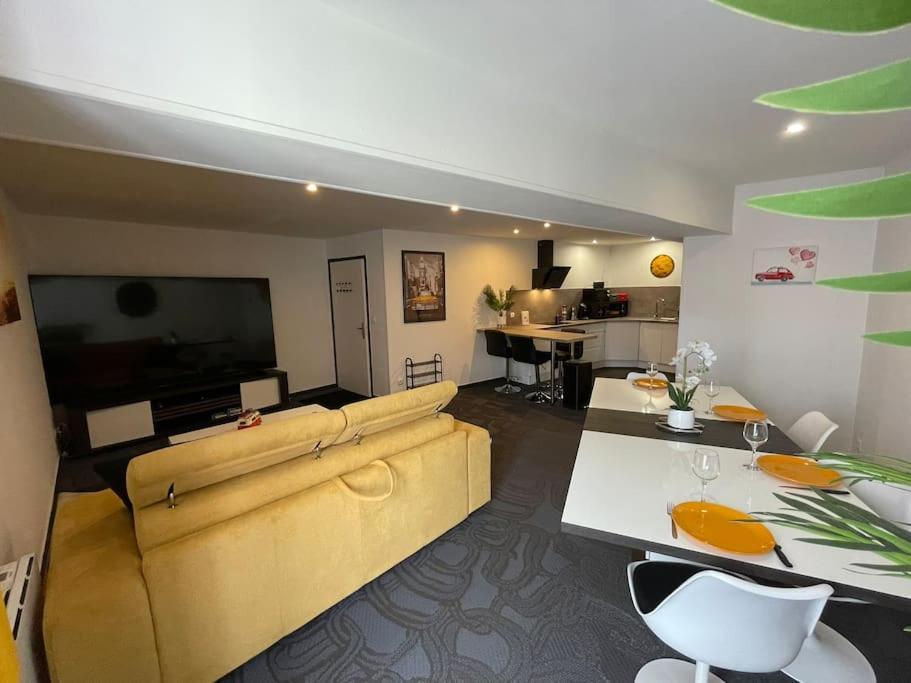 a large living room with a couch and a television at L'appart écran Géant in Joinville