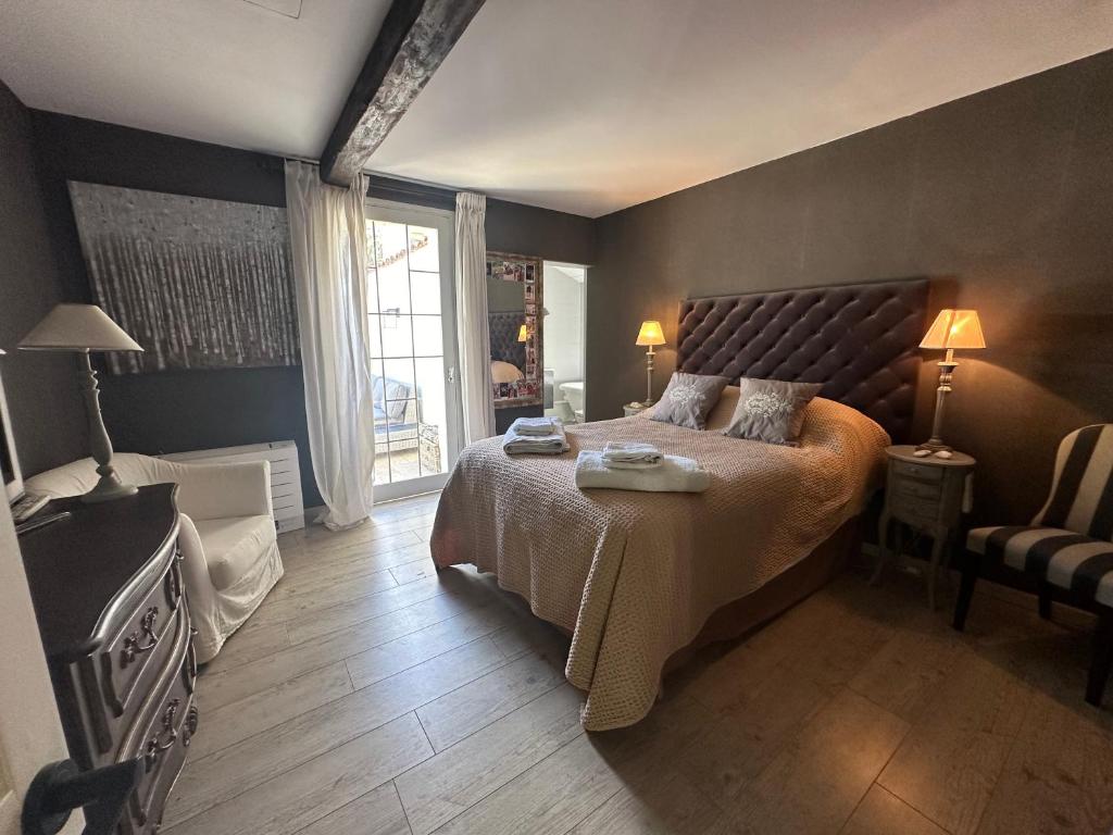 a bedroom with a large bed and a window at Central Valbonne Villa in Valbonne