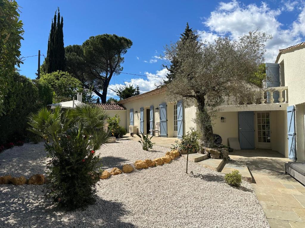 a house with a garden in front of it at Central Valbonne Villa in Valbonne