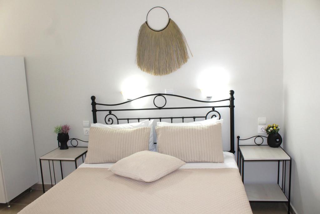 a bedroom with a black bed with two tables at Fissas Rooms in Sivota
