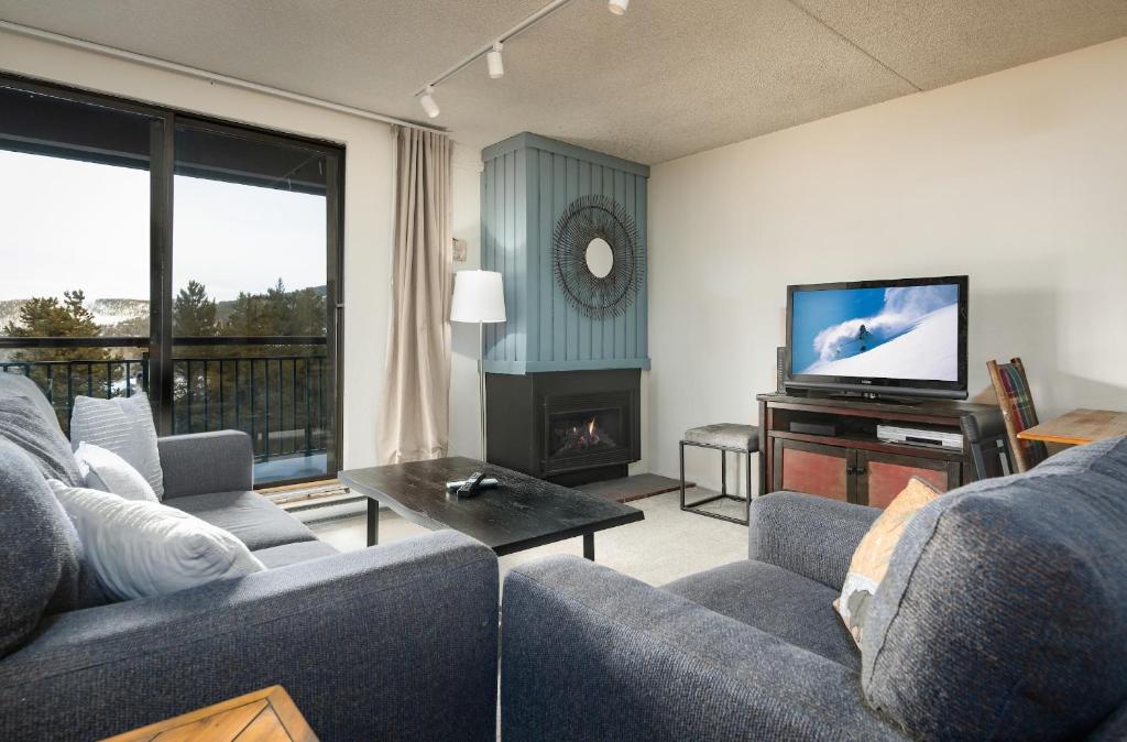 a living room with two couches and a television at Trails End Easy Rest Condo: Ski In/Out, Stroll To Main Street in Breckenridge