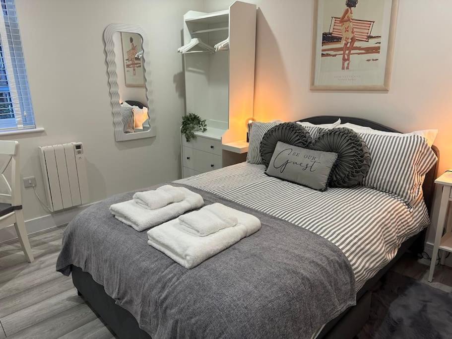 a bedroom with a bed with two towels on it at Luxury 2 bedroom apartment in Belper