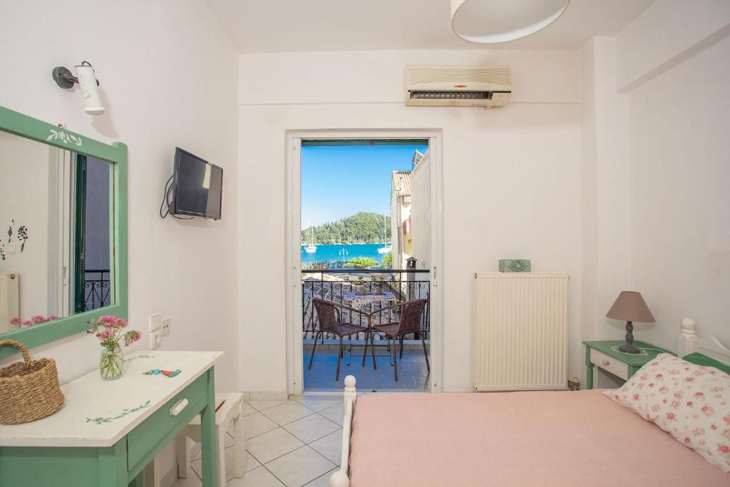 a bedroom with a bed and a view of the ocean at A2- Alexandri Apartment in Nydri
