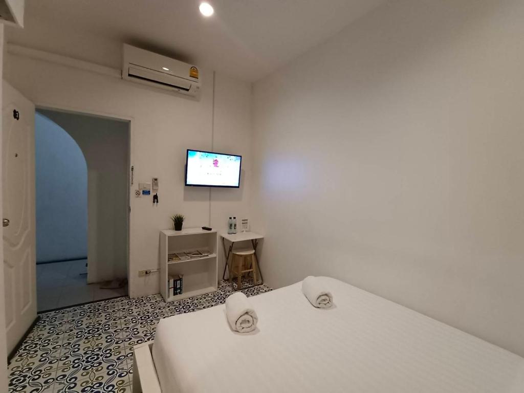 Postel nebo postele na pokoji v ubytování Chino Town at Yaowarat Phuket - SHA Plus