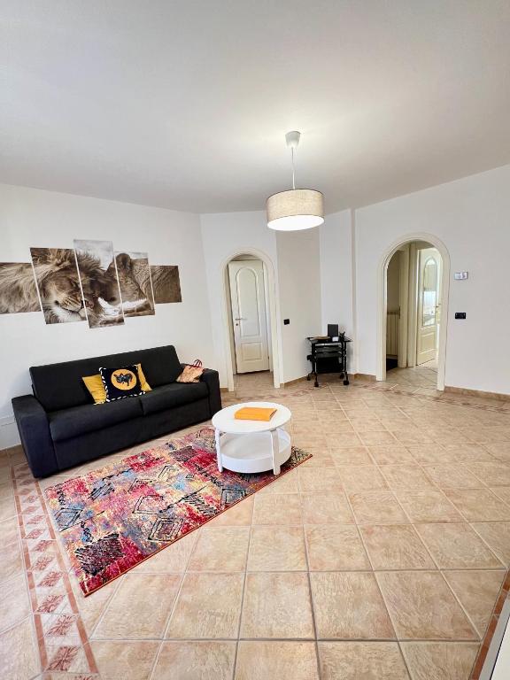 a living room with a couch and a table at LA Home - Animal House in Viareggio
