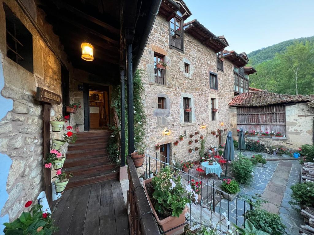 an outside view of a building with a wooden porch at Posada la Trebede in Perrozo