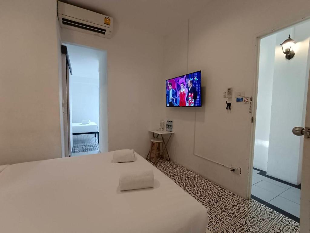 Postel nebo postele na pokoji v ubytování Chino Town at Yaowarat Phuket - SHA Plus