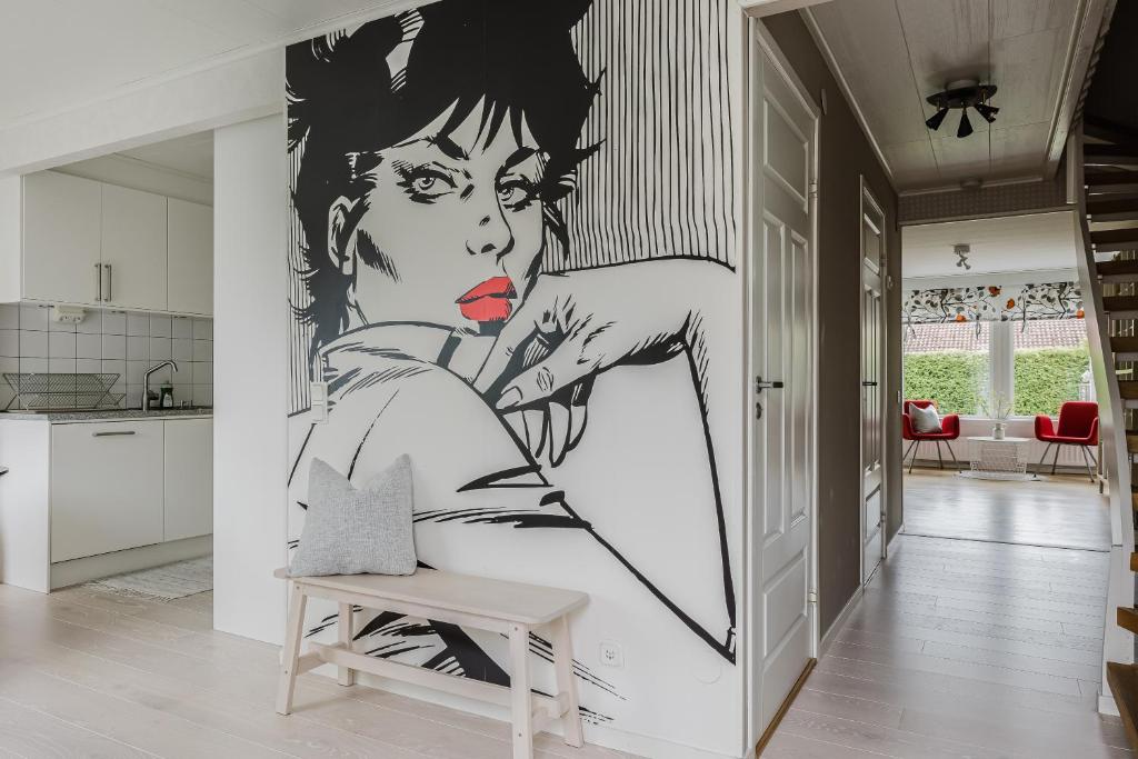 a mural of a woman on a wall in a kitchen at Cozy townhouse 7 beds in Stockholm County in Kungsängen