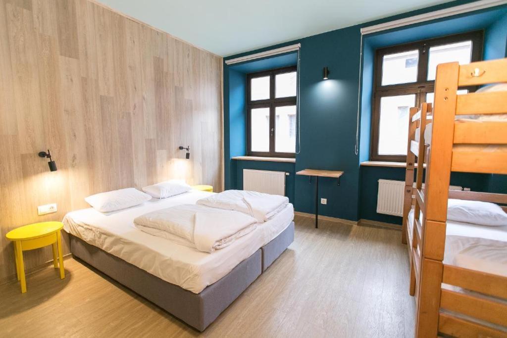 ein Schlafzimmer mit 2 Betten und einer blauen Wand in der Unterkunft DREAM Hotel Lviv in Lwiw