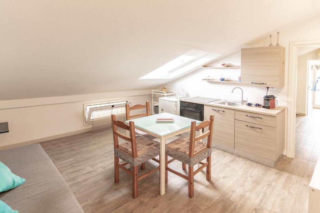 a kitchen with a table and chairs in a room at La Vela dei Sogni in Misano Adriatico